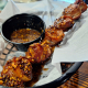 Bacon-wrapped sausage bites with black garlic honey glaze at True Grit American Bistro.