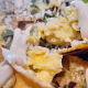 CHILAQUILES VERDE Tortilla chips simmered in tomatillo salsa with scrambled eggs & cheddar topped with cotija cheese and Mexican crema.